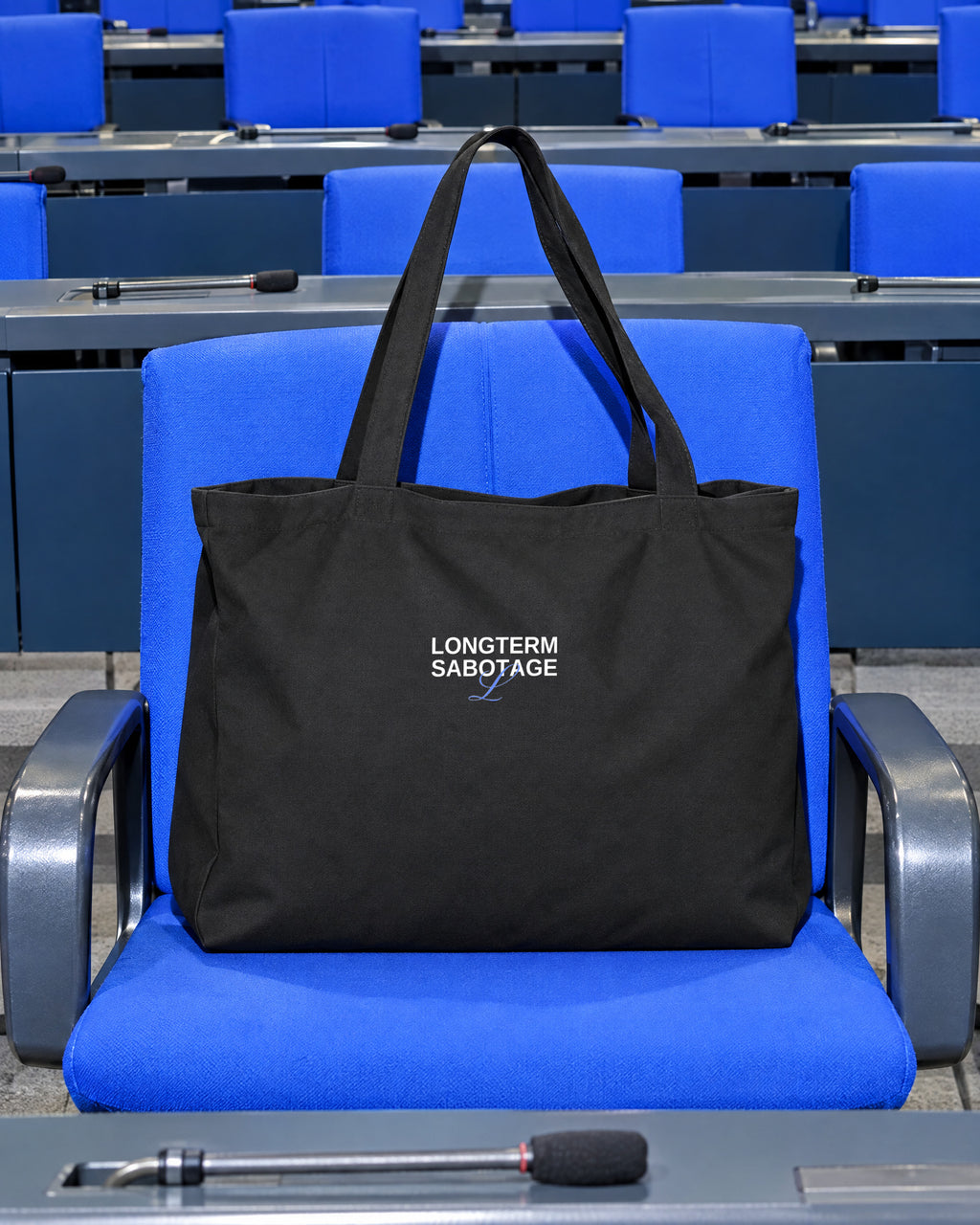 LONGTERM SABOTAGE Large Tote, Black, on a Bundestag chair